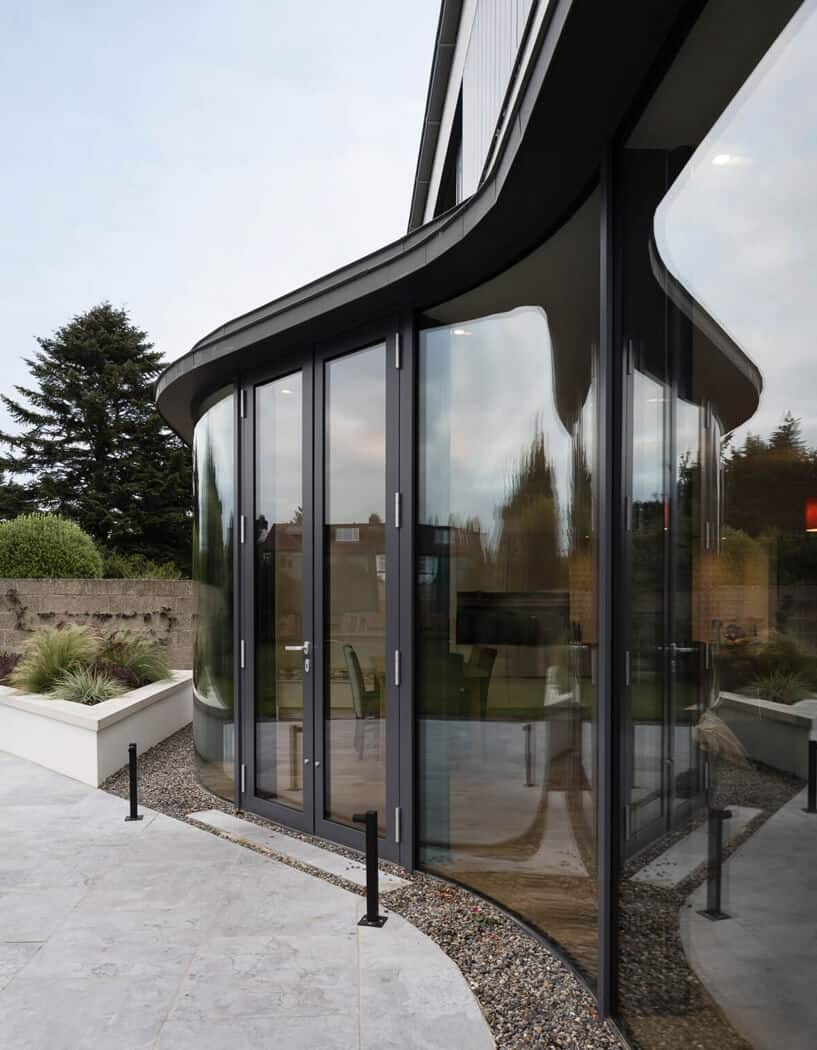Curved glazed screen with zinc roof