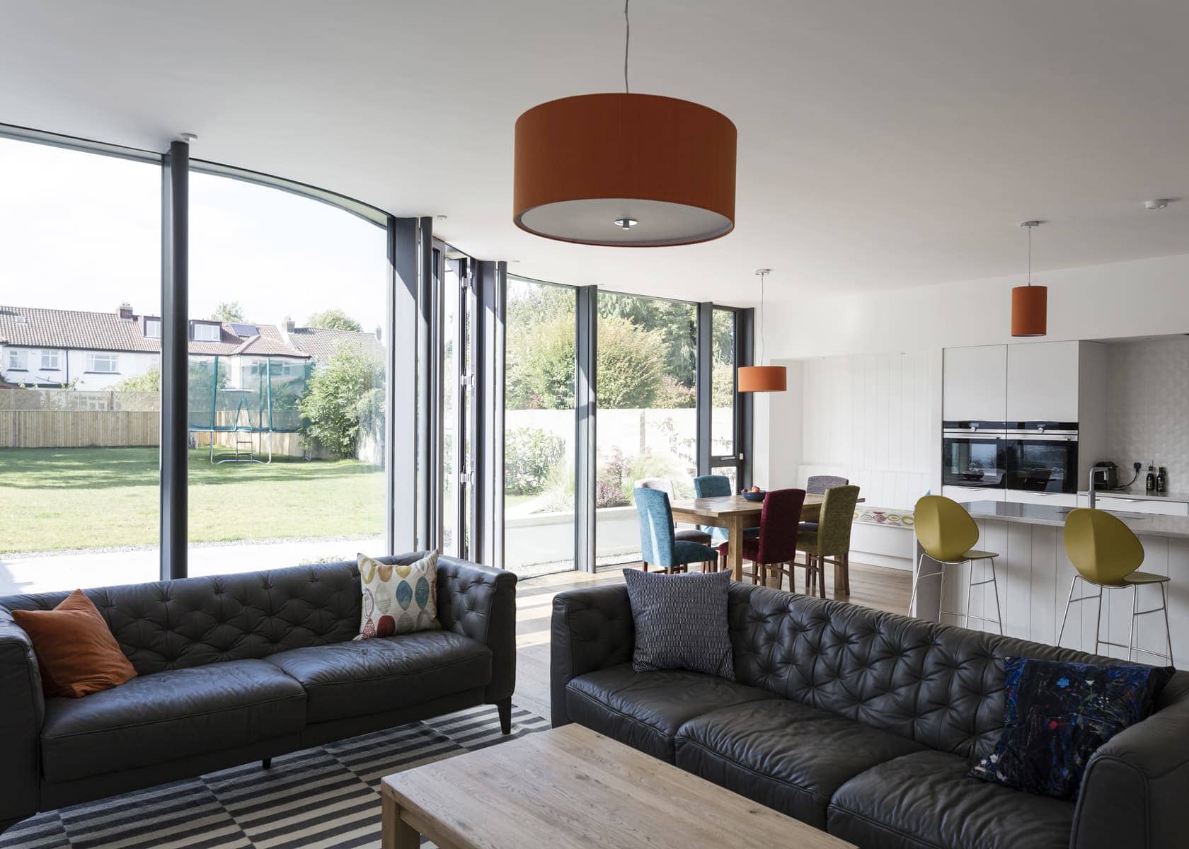 Contemporary living space in Dublin, designed by architects, with panoramic windows and a sleek kitchen