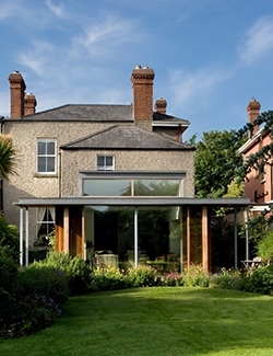 Elegant two-story Victorian period home with a modern glazed extension, nestled in a lush garden setting in Sandymount, South Dublin